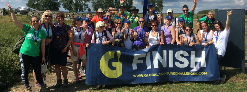 Hadrian's wall trek - participants holding finish banner